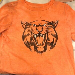 Orange tiger shirt - GAP kids small.  Teeth and eyes glow in the dark!